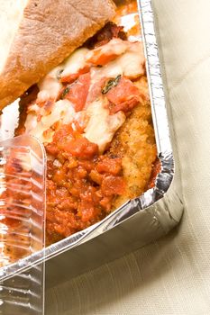 carry out meal chicken parmesan with a slice of bread in the carry out container