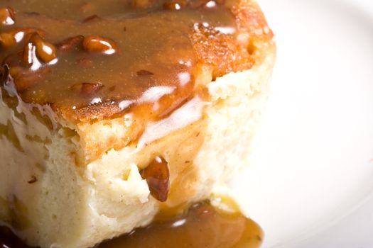 fresh hot bread pudding topped with caramel syrup and pecans