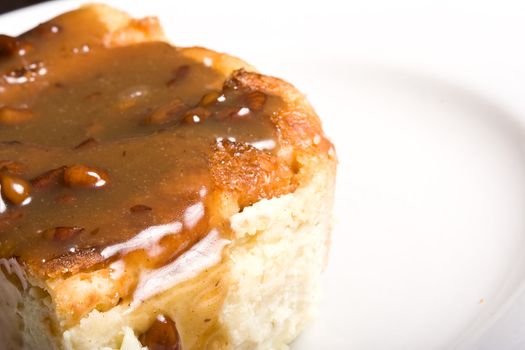 fresh hot bread pudding topped with caramel syrup and pecans