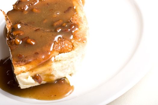 fresh hot bread pudding topped with caramel syrup and pecans