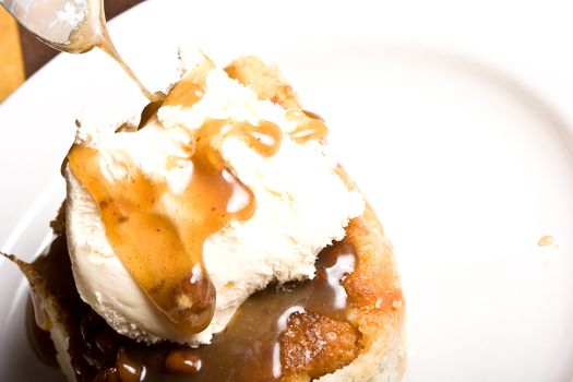 fresh hot bread pudding topped with caramel syrup and pecans