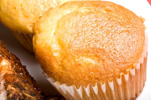 fresh hot homecooked cornbread muffins close up on a white plate