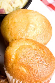 fresh hot homecooked cornbread muffins close up on a white plate