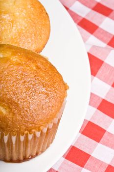 fresh hot homecooked cornbread muffins close up on a white plate