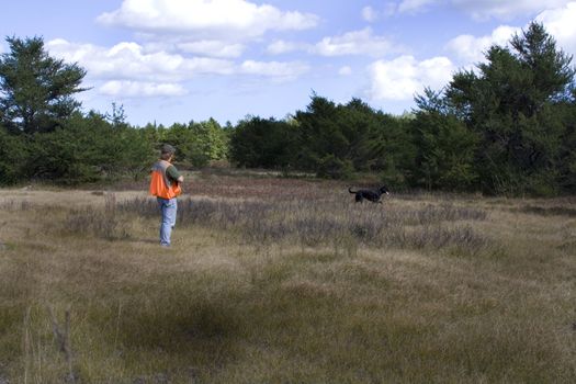 Man and dog out bird hunting in northern michigan