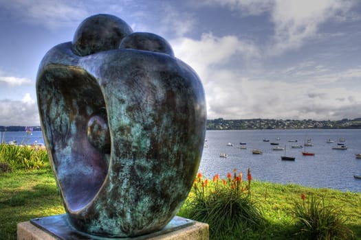 sculpture of a couple in the foreground and background breton landscape