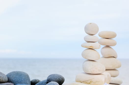 Two pile of pebbles in the balance on the seacoast