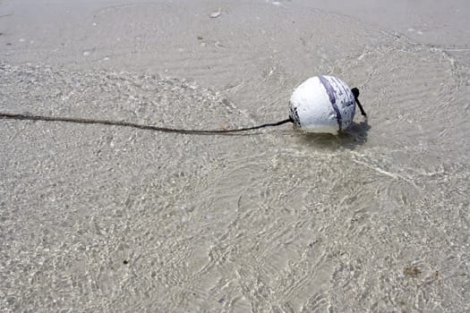 buoy floating alone in the ocean looking lonely