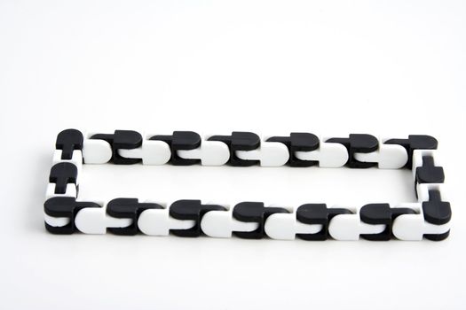 a chain toy that teachers give to students that have adhd or add to help them focus while studying over white background