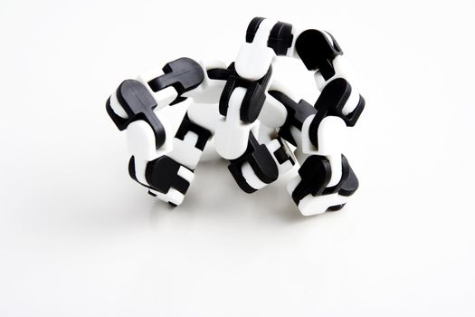 a chain toy that teachers give to students that have adhd or add to help them focus while studying over white background