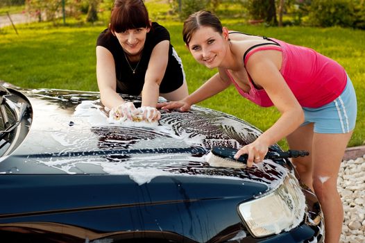 Adult cleaning her car outside