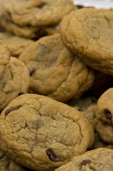 a close up of a mountain of chocolate chip cookies hot to go