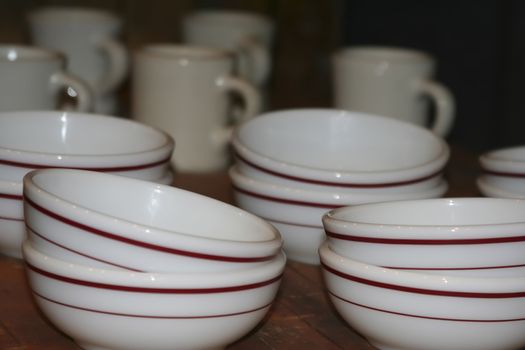 close up of old bowles and coffee cups white with brown stripes