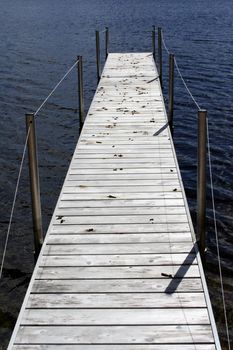 long dock with goose droppings in northern michigan on a small lake