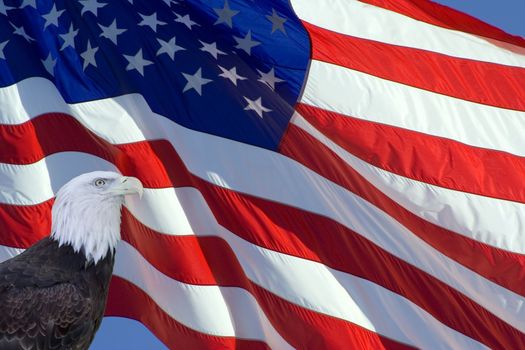 Tilted stars and stripes flying in the wind on deep blue sky nice background for a patriotic display