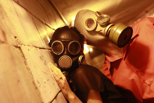 Married couple in gas masks in a tunnel