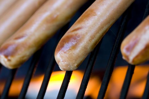 A summer bbq staple hotdogs on the grill close up shots shallow depth of view nice grill marks 