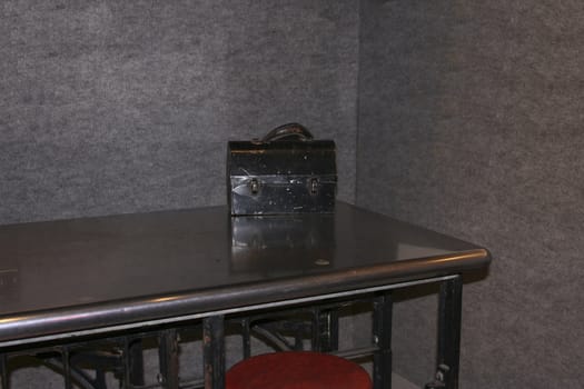 old black lunch box in the break room on a steel table