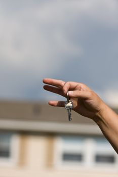 woman handing another woman keys to a house