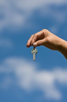 woman handing another woman keys to a house