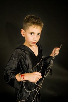 on boy with barbed wire, dressed for halloween.