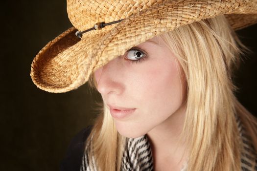 Blonde teenager wearing a straw cowboy hat