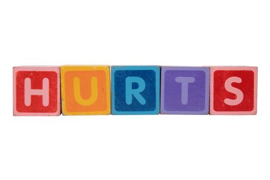 toy letters that spell hurts against a white background with clipping path