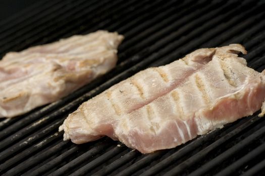 Pork chops on the grill.  Grill marks and close up detail