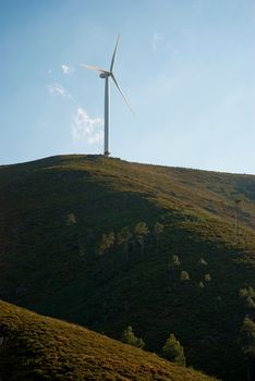 Wind turbine on a hill generating electricity.