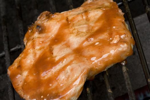 Pork chops on the grill.  Grill marks and close up detail