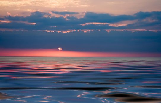 colorful sunset over smooth waves striking colors