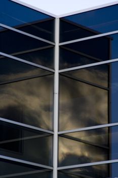 cloud reflections in office building window glass