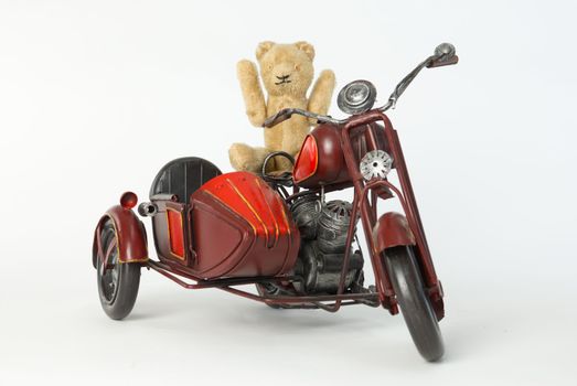 Teddy riding a motorbike toy