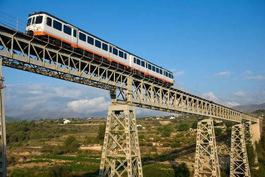 Narrow gauge train crossing a bridge in scenic location