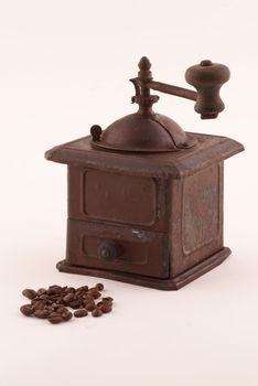 Vintage iron coffee grinder with coffee beans