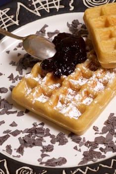 Freshly baked belgian waffles with raspberry marmelade