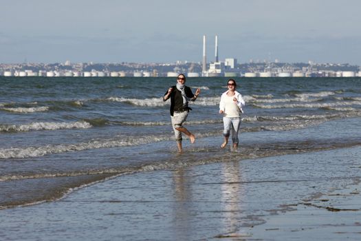 Two girls run on coast. France