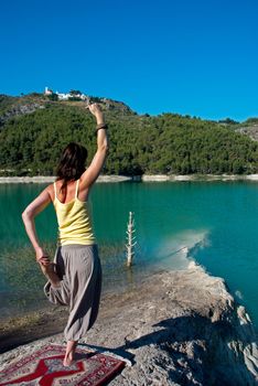 Early morning yoga on the shores of a lake