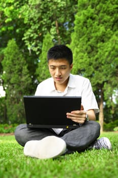 asian man using computer outdoor