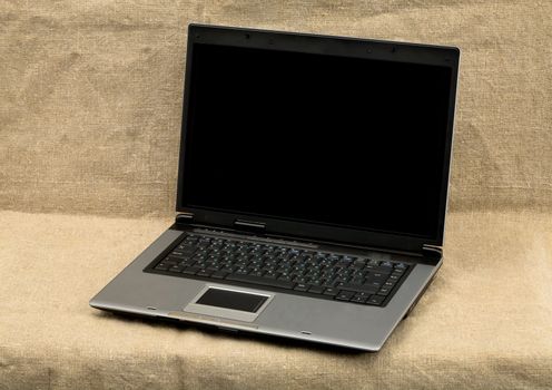 Laptop on the brown sacking background