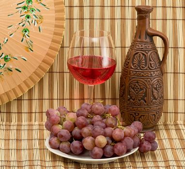 Still life with Bottle, bucket, goblet and grapes