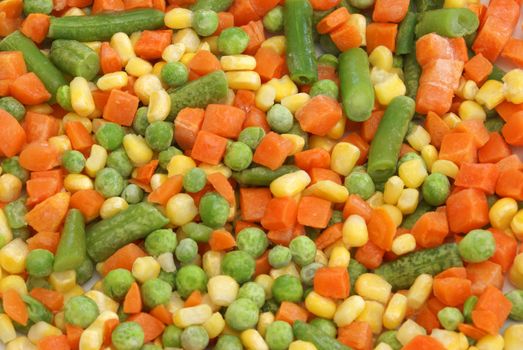 A macro of frozen peas, carrots, corn, and green beans.