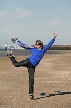 The cheerful adult woman at coast of ocean. France