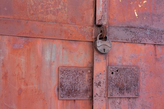 Rusty iron gates locked on old lock