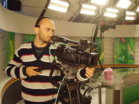 an image with a television cameraman working with camera