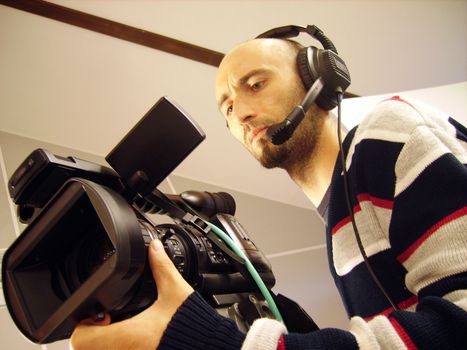 an image with a television cameraman working with camera