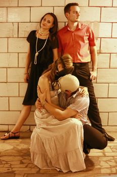 Two married couples in a tunnel one of pairs in gas masks