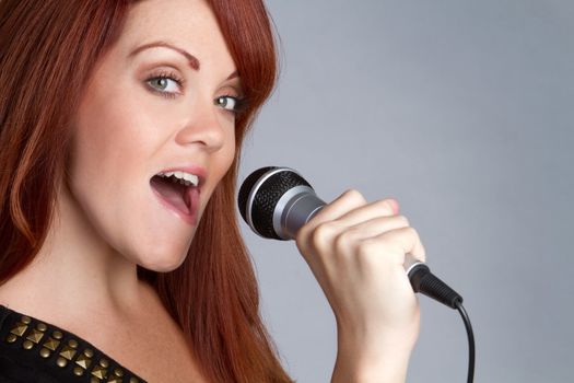 Pretty redhead girl singing karaoke
