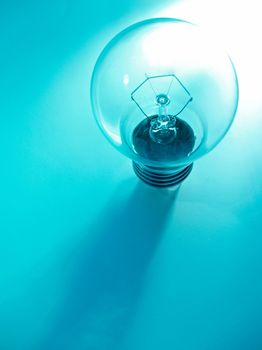 The picture of an electric lightbulb on blue background
