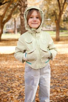 Girl in autumn park, six years old, blonde, caucasian